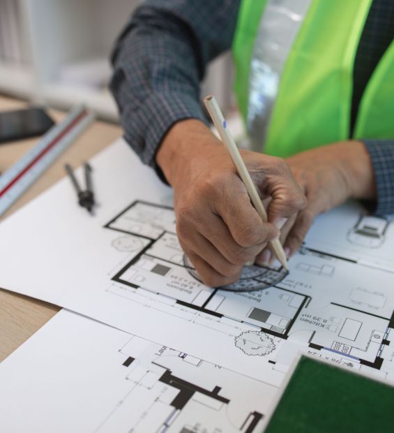businessman or architect with model of a house working in office, architect working in office with blueprints, engineer inspect architectural plan, sketching a construction project, business concept,